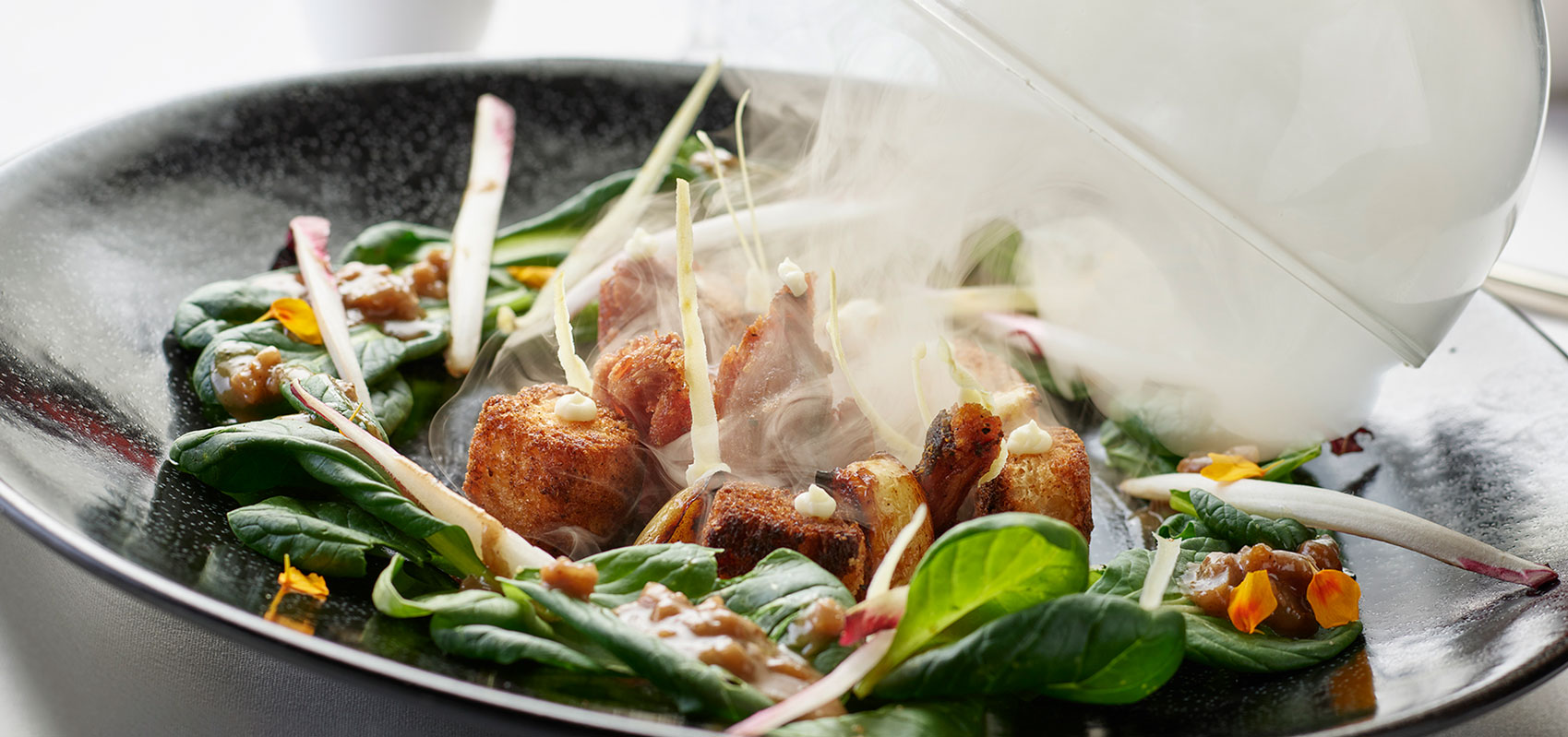 steaming fried food with greens