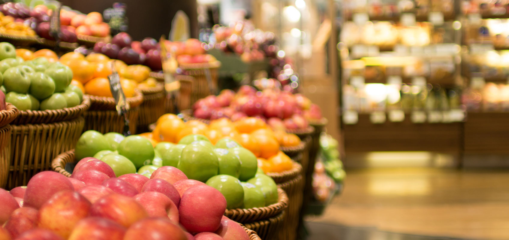 multicolored apples in baskets in a grocery store