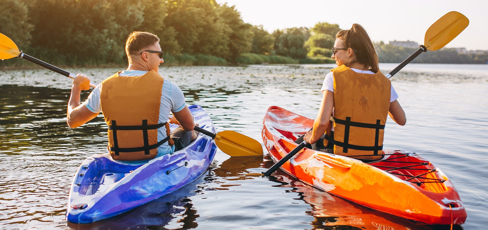 man and woman kayaking sharing glances
