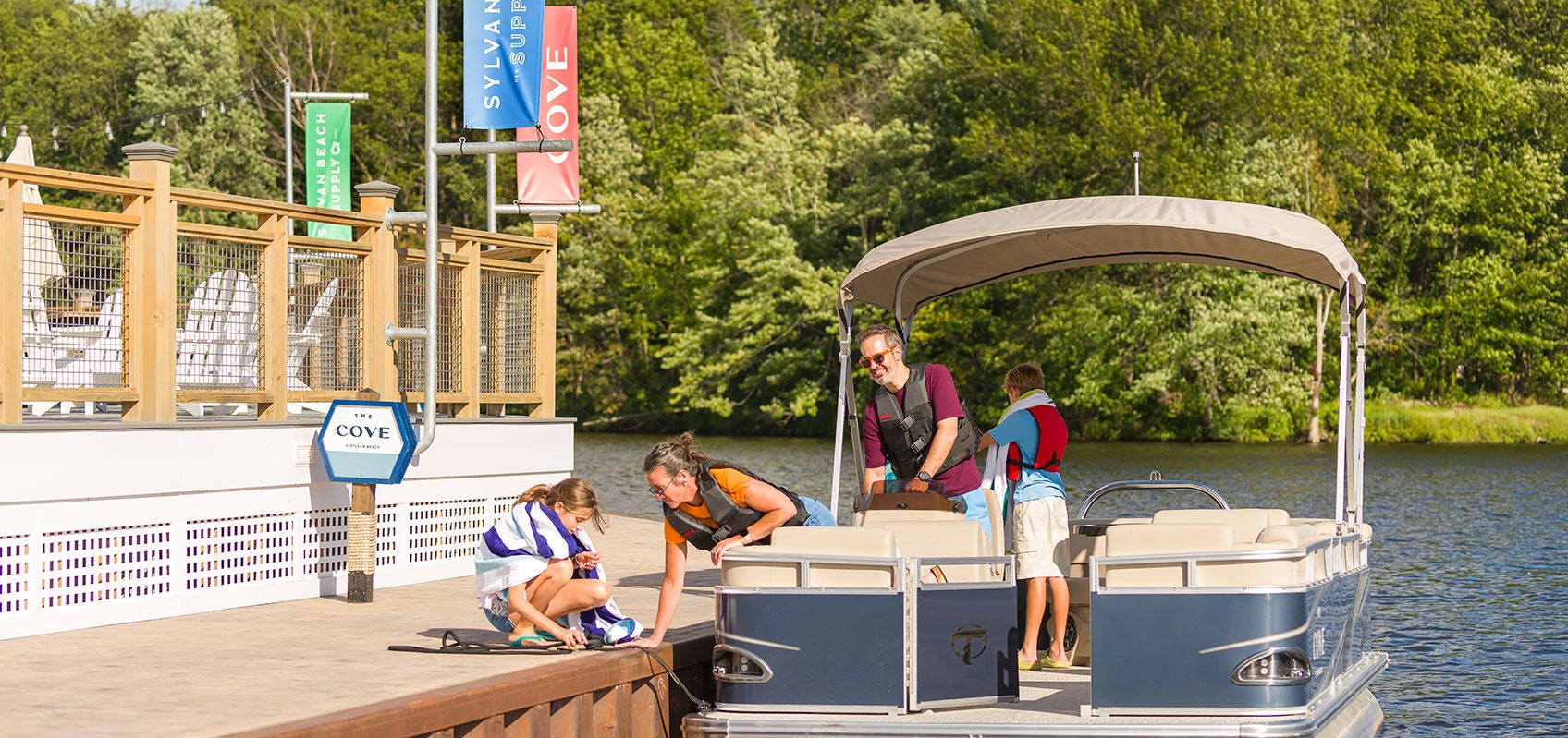 Family ropes off docked pontoon boat