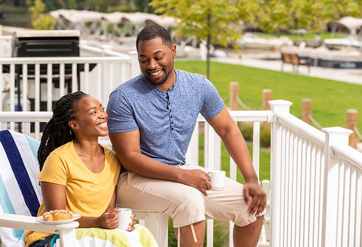 Couple sits outside the Quarters apartments