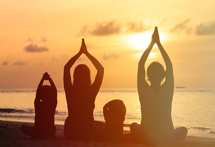 family doing Beach Yoga at Sylvan Beach