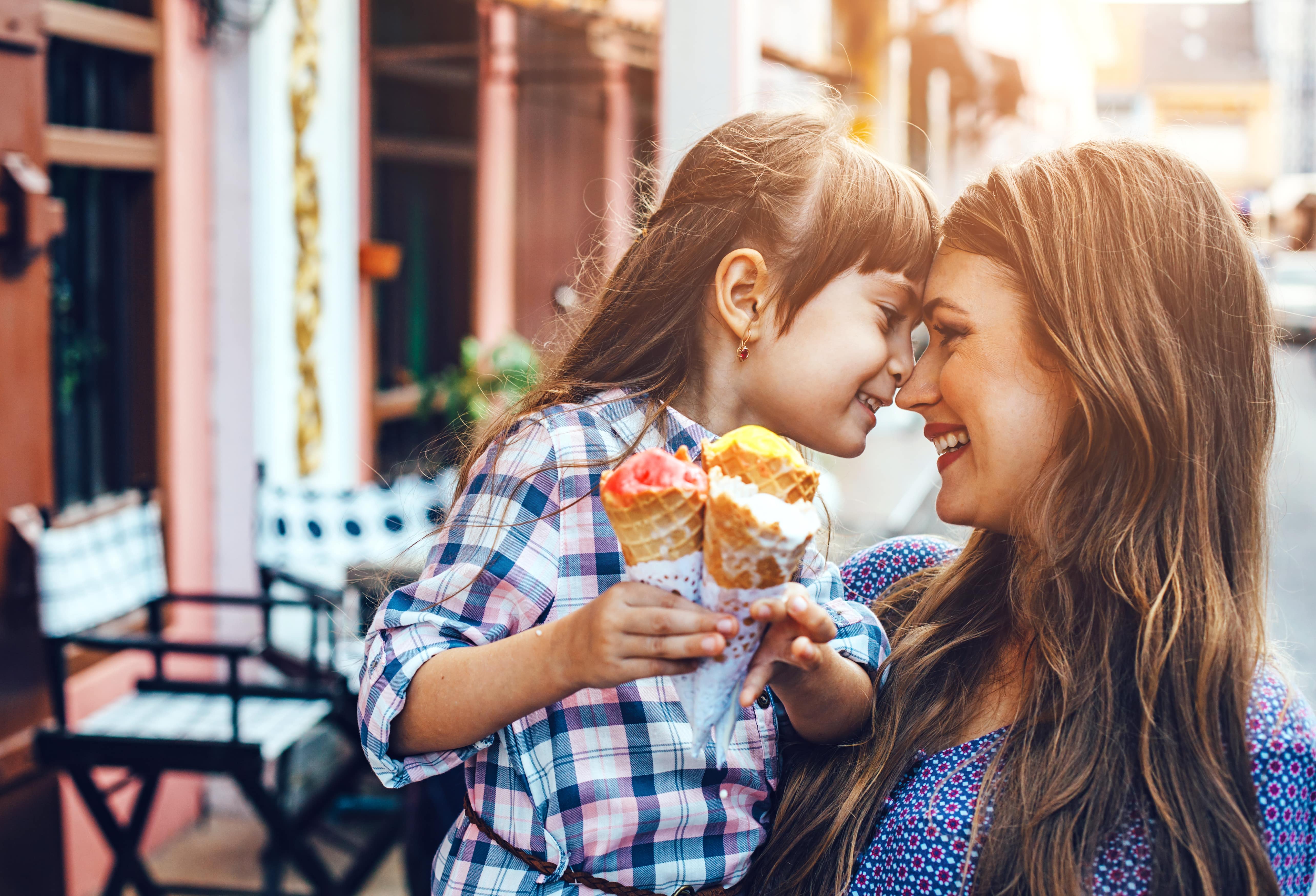happy mom and daughter with ice cream cones