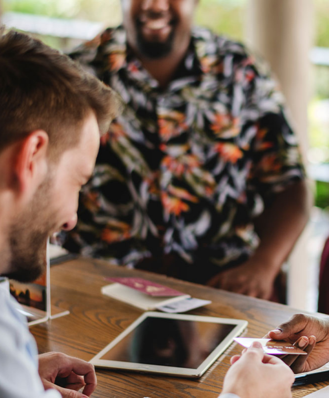 man handing credit card to guest