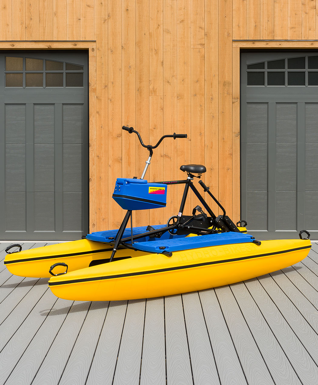 blue and yellow water bike on wooden dock
