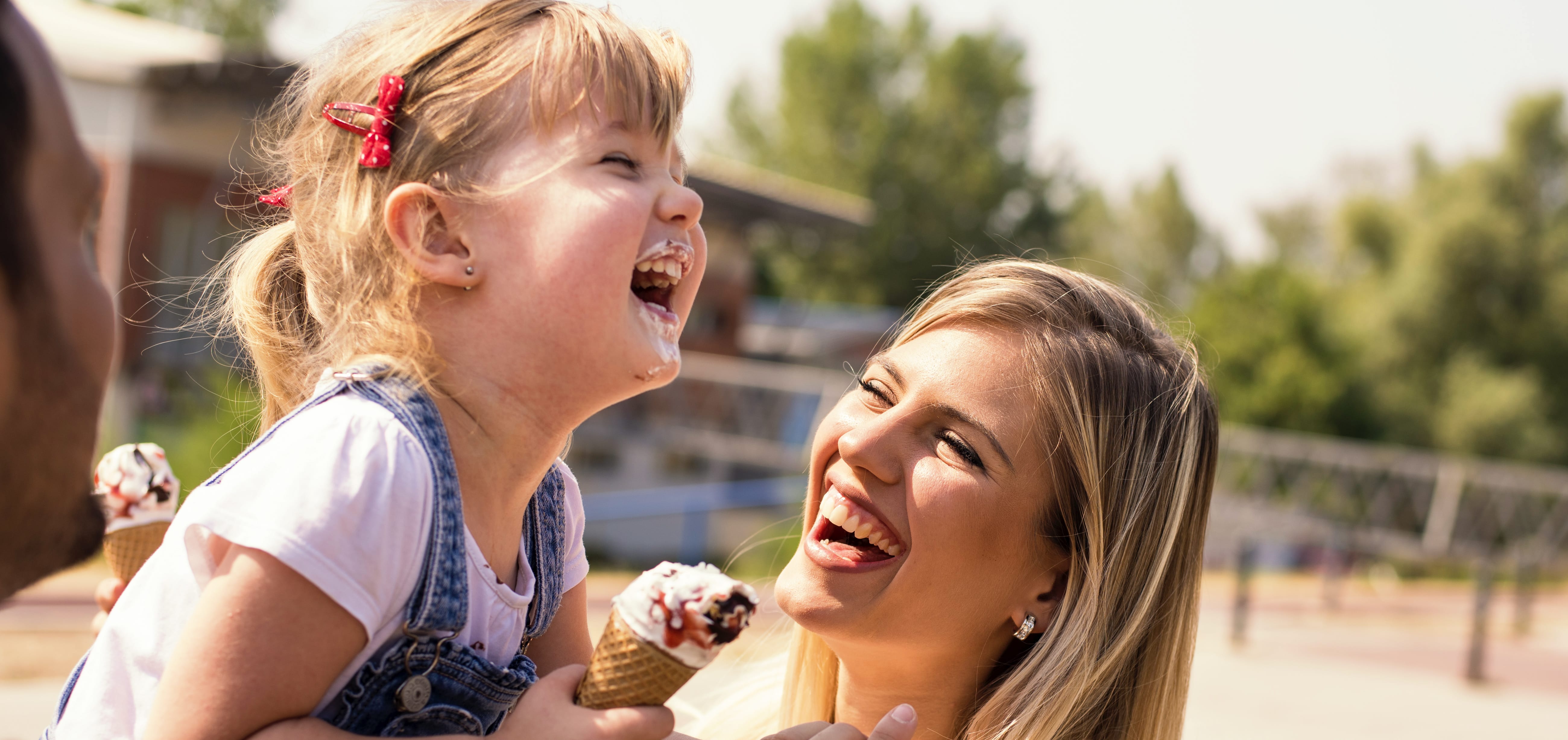 mother and daughter laughing over ice cream