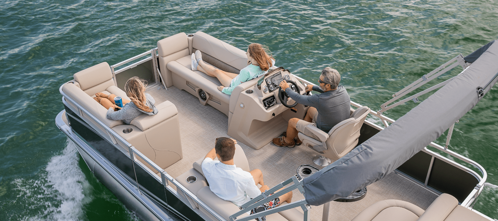 family of four enjoying a pontoon boat ride