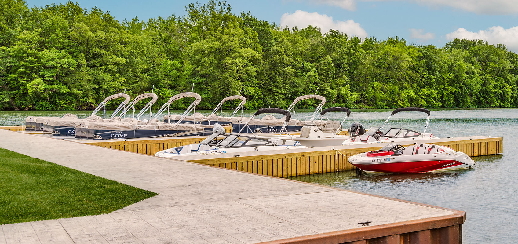 Pontoon, deck and ski boats docked at Sylvan Beach Supply Co